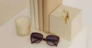 Burgundy Selen Eyewear sunglasses on a luxury display table