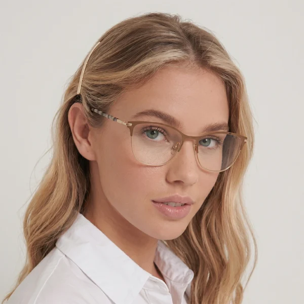 Blonde woman wearing champagne gold Selen Eyewear glasses