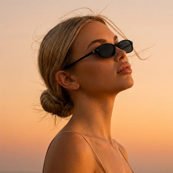 Blonde woman wearing black Selen Eyewear sunglasses at sunset