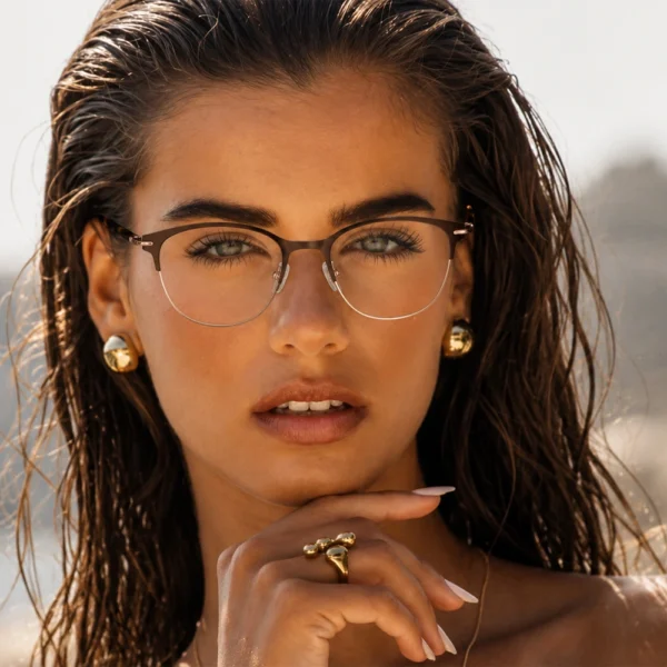 Woman wearing brown gold Selen Eyewear glasses by the beach