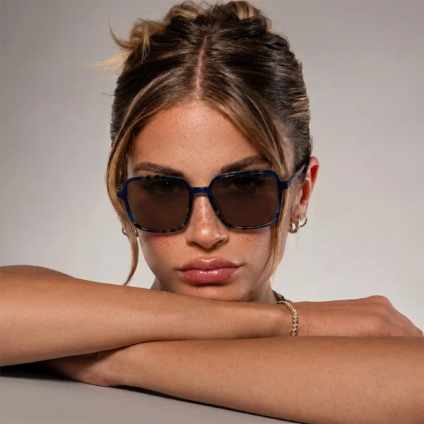 Woman wearing dark blue Selen Eyewear sunglasses in a studio portrait