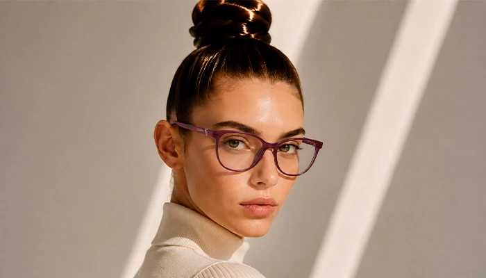 Woman wearing purple Selen Eyewear glasses in warm light