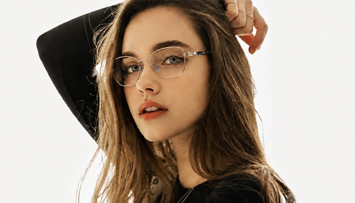 oung woman wearing thin round Selen Eyewear glasses