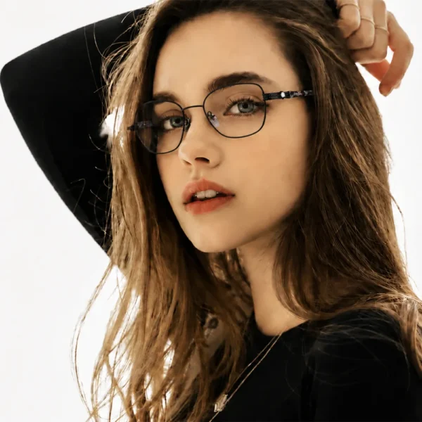 Woman wearing Selen Eyewear full-rim metal optical glasses in a close-up fashion portrait.