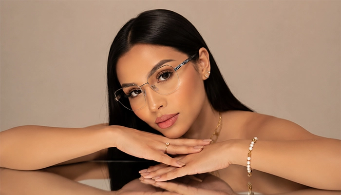 Woman wearing Selen Eyewear full-rim metal optical glasses in a modern beauty portrait.