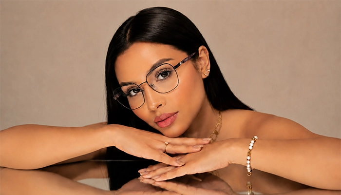 Woman wearing Selen Eyewear full-rim metal optical glasses in an elegant studio portrait