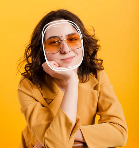 Woman wearing orange lens Selen Eyewear glasses on a yellow background